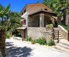 Two Istrian stone houses with a view of the surrounding hills, Oprtalj, Istria